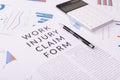 Work injury claim form concept, documents on the desktop Royalty Free Stock Photo