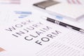 Work injury claim form concept, documents on the desktop Royalty Free Stock Photo