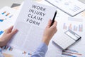 Work injury claim form concept, documents on the desktop Royalty Free Stock Photo