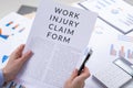 Work injury claim form concept, documents on the desktop Royalty Free Stock Photo
