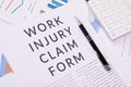 Work injury claim form concept, documents on the desktop Royalty Free Stock Photo
