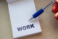 The WORK inscription on note. Word WORK on paper