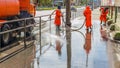 Work janitors wash the sidewalk with a stream of water from a hose on the Moscow Highway on a spring sunny day