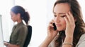 Work just isnt working out. a young businesswoman using a smartphone and looking stressed in a modern office.