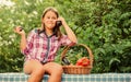 At work. Kid on summer farm. Organic food. Little girl vegetable in basket. Only natural. Healthy food for children