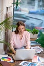 Beautiful girl working at a laptop in the office.