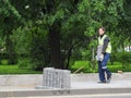 Work on laying the new tile on a city street. Lays the new tile on the floor. Paving in the city. A man carries building tiles. Ru