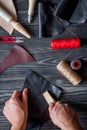 Work in leather shop on dark wooden background top view