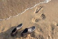 Work Life Balance Concept, Businessman take off his Working Shoes and leave it on the Sand Beach for Walk into the Sea Royalty Free Stock Photo