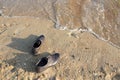 Work Life Balance Concept, Businessman take off his Working Shoes and leave it on the Sand Beach for Walk into the Sea Royalty Free Stock Photo