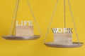 Work and life balance concept. Balance scales on yellow background, close up Royalty Free Stock Photo