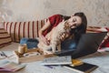 Work-life balance, Home office, work space, work from home, Flexible work hours concept. Young woman with laptop and cat Royalty Free Stock Photo