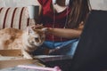 Work-life balance, Home office, work space, work from home, Flexible work hours concept. Young woman with laptop and cat Royalty Free Stock Photo