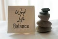 Work life balance message on a notepaper with zen stones on the table on white background. Life balance, peace, harmony concepts. Royalty Free Stock Photo