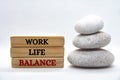 Work life balance text on wooden blocks with balanced zen stones. Working culture concept. Royalty Free Stock Photo