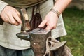 Work of a medieval blacksmith for the manufacture of metal products. Royalty Free Stock Photo