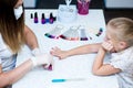 Work in nail studio master with the client child. Royalty Free Stock Photo
