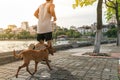 Work out with dog. Asian male running with his dog in the park