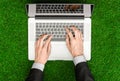 Work outdoors and businessman topic: human hands show the gestures in a black suit and an open notebook on a background of green g Royalty Free Stock Photo