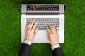 Work outdoors and businessman topic: human hands show the gestures in a black suit and an open notebook on a background of green g Royalty Free Stock Photo