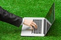 Work outdoors and businessman topic: human hands show the gestures in a black suit and an open notebook on a background of green g Royalty Free Stock Photo