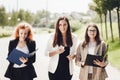 Work outside the office. Three successful caucasian businesswomen in suits standing on the street Royalty Free Stock Photo