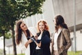 Work outside the office. Three successful caucasian businesswomen in suits standing on the street Royalty Free Stock Photo