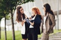 Work outside the office. Three successful caucasian businesswomen in suits standing on the street Royalty Free Stock Photo