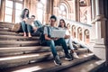 Work with the people that motivate and inspire you.Group of students studying while sitting on stairs in university Royalty Free Stock Photo