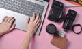 The work of the photographer, photo retouching. Photographic equipment, female hands typing on laptop keyboard Royalty Free Stock Photo