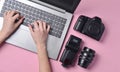 The work of the photographer, photo retouching. Photographic equipment, female hands typing on laptop keyboard Royalty Free Stock Photo