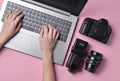 The work of the photographer, photo retouching. Photographic equipment, female hands typing on laptop keyboard Royalty Free Stock Photo