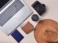 Work of the photojournalist. Laptop, wallet, passport, hat, camera, lens. Travel concept, top view, flat lay. Royalty Free Stock Photo
