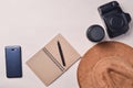 Work of the photojournalist. Smartphone, notebook, hat, camera, lens. Travel concept, top view, flat lay. Royalty Free Stock Photo