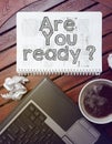 Work place - table with notebook with question: are you ready ?