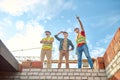 Men standing on brick wall of building under construction Royalty Free Stock Photo