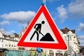 Work in progress road sign triangle isolated on cloudy background Royalty Free Stock Photo