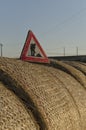 Work in progress roadsign over straw round bales