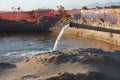 Work in progress on the sandy beach. open yard, between pipes and orange bars before the seasonal summer open sea Royalty Free Stock Photo