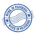 WORK IN PROGRESS, text written on blue postal stamp Royalty Free Stock Photo