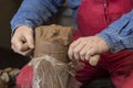 Work with red clay. Male hands form a bowl on a spinning pottery wheel. Royalty Free Stock Photo