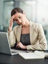 Work related stress - the struggle is real. a businesswoman looking stressed out at her office desk.