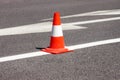 Work on road. Construction cone. Traffic cone, with white and orange stripes on asphalt. Street and traffic signs for signaling. Royalty Free Stock Photo