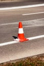 Work on road. Construction cone. Traffic cone, with white and orange stripes on asphalt. Street and traffic signs for signaling. Royalty Free Stock Photo