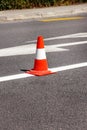 Work on road. Construction cone. Traffic cone, with white and orange stripes on asphalt. Street and traffic signs for signaling. Royalty Free Stock Photo