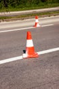 Work on road. Construction cones. Traffic cone, with white and orange stripes on asphalt. Street and traffic signs for signaling. Royalty Free Stock Photo