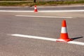 Work on road. Construction cones. Traffic cone, with white and orange stripes on asphalt. Street and traffic signs for signaling. Royalty Free Stock Photo