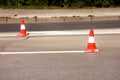 Work on road. Construction cones. Traffic cone, with white and orange stripes on asphalt. Street and traffic signs for signaling. Royalty Free Stock Photo