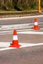 Work on road. Construction cones. Traffic cone, with white and orange stripes on asphalt. Street and traffic signs for signaling. Royalty Free Stock Photo