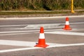 Work on road. Construction cones. Traffic cone, with white and orange stripes on asphalt. Street and traffic signs for signaling. Royalty Free Stock Photo